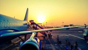 Airplane landing on the runway at sunset