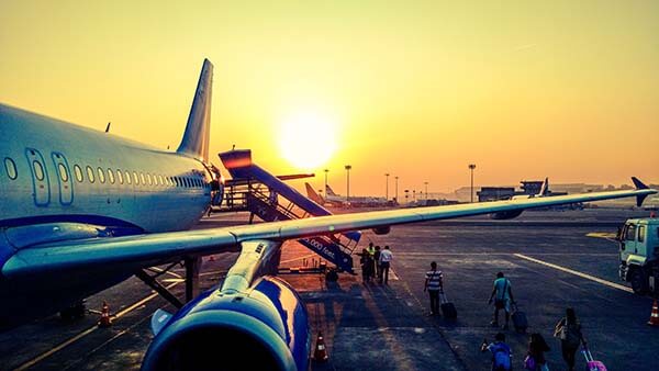 Airplane landing on the runway at sunset