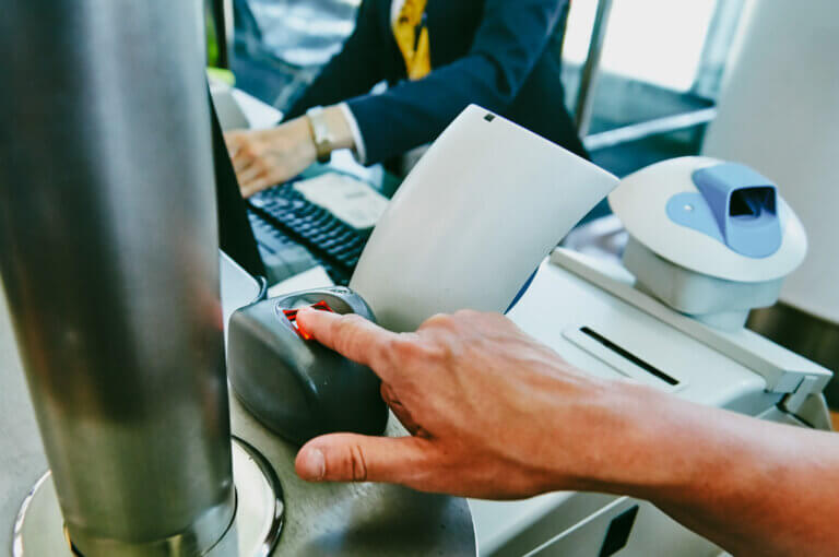 Biometric control in airport Woman puts her finger on scanner a - Midas Travel Management Border changes for the business traveller