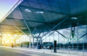 stansted airport london uk midas travel management midas travel management modern airport terminal exterior with glass walls and exposed steel framework in morning sunlight