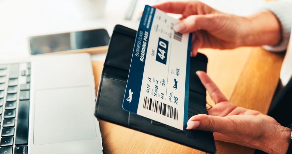 laptop ticket and hands of business woman in office for online booking work trip and schedule corporate workplace and person on computer with flight info for agenda travel admin and planning midas travel management keep copies of important documents for corporate trips